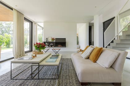 Sin puertas, solo vanos, más allá del living se ubica un pequeño espacio para ver tele