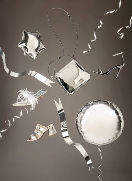 Slipper plateado con plumas (Las Pepas). Sandalias plata de cuero (Lomm). Mini bag plata (Prüne). Sandalia con pulsera (Sarkany).