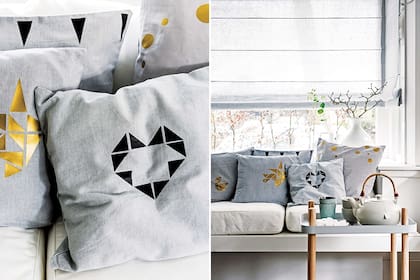 Sobre almohadones grises, apliques en negro y dorado que forman diversos dibujos