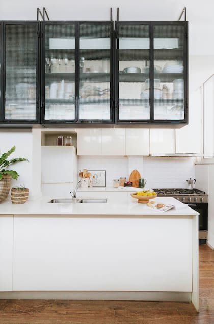 Sobre una reforma anterior, se sumó esta estantería de vidrio: más lugar de guardado, accesible también desde el estar.