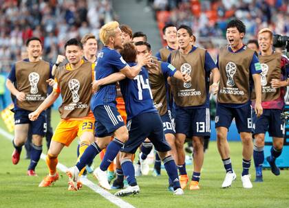 Soccer Football - World Cup - Group H - Japan vs Senegal - Ekaterinburg Arena, Yekaterinburg, Russia - June 24, 2018 Japans Takashi Inui celebrates scoring their first goal with team mates REUTERS/Max Rossi