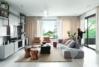 Sofá (Helmut) con almohadones (Lote Propio). Sillones con tapizado en pana (Tapicería Carlos Méndez). Alfombra (Awanay).