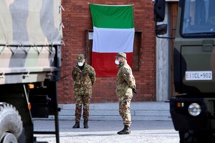 Soldados de la armada italiana esperan afuera de la iglesia