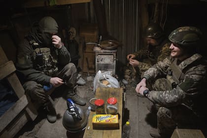 Soldados ucranianos charlan en un refugio en la línea del frente, cerca de Avdiivka, región de Donetsk, Ucrania, el viernes 22 de marzo de 2024.
