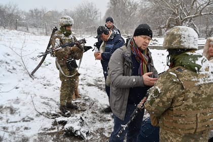 Soldados ucranianos revisan documentos de hombres que salen de la ciudad de Irpin