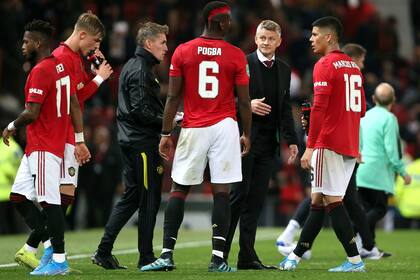 Solskjaer charla con algunos jugadores de Manchester United antes de la tanda de penales.