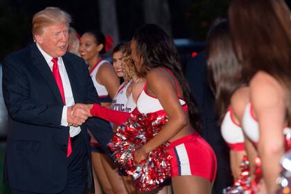 El presidente de los Estados Unidos, Donald Trump, saluda a las porristas de la Florida Atlantic University antes del comienzo del Super Bowl en el Trump International Golf Club en West Palm Beach