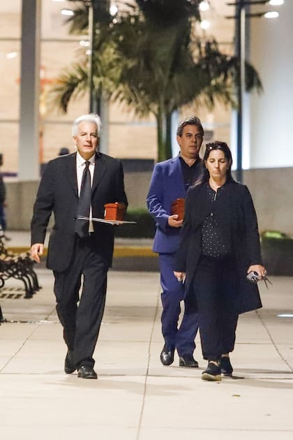 Sus hijos Álvaro y Gonzalo llevan las dos urnas con las cenizas del escritor. Unos pasos más adelante, su hija Morgana camina conmovida.