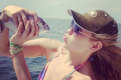 Thalía a punto de besar un pez