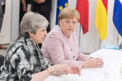 Theresa May y Angela Merkel, en el G-20