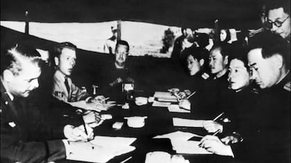 This file photo taken in 1951 at Panmunjom shows North Koreans and US liaison officers discussing an armistice. North Korea warned on May 27, 2009 of a military response after South Korea joined an anti-proliferation exercise, and said it is no longer bound by the armistice which ended the Korean Wa
