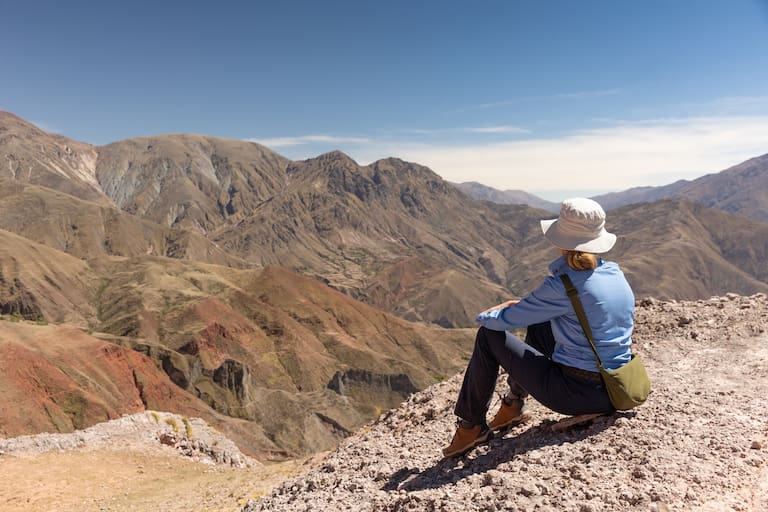 El carguero acompaña con una mula de apoyo y burros que trasladan el equipaje. Ofrendas en una apacheta del camino. (Fotos: Belén Grosso)