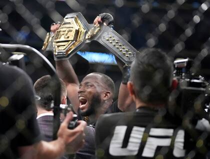 UFC fighter Leon Edwards, of Jamaica, celebrates his title as welterweight champion of the world after knocking out Nigerian UFC fighter Kamaru Usman during the UFC 278 mixed martial arts title bout in Salt Lake City on Saturday, Aug. 20, 2022. (Francisco Kjolseth/The Salt Lake Tribune via AP)