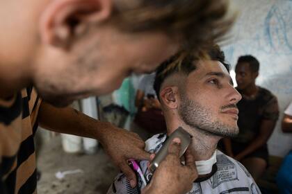 Un barbero corta la barba de un cliente en una barbería de La Habana, el 7 de agosto de 2019