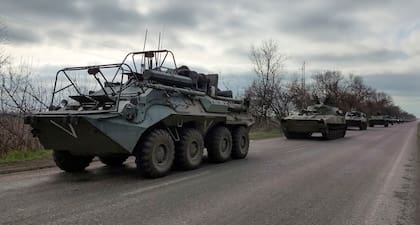 Un convoy militar ruso se mueve en una carretera en una zona controlada por las fuerzas separatistas respaldadas por Rusia cerca de Mariupol, Ucrania, el sábado 16 de abril de 2022