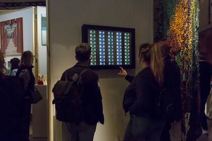 Un grupo de personas mira "VU", de Luciano Colman exhibido en la galería Sasha D