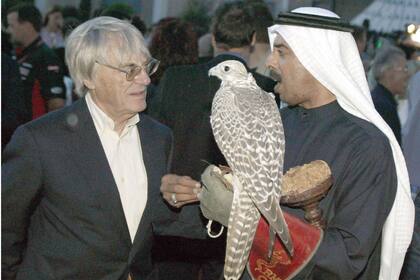 Un jeque de Bahrein con un halcón peregrino, durante una charla con el jefe de la Fórmula 1 Bernie Eccleston, en 2003