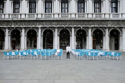 Un mozo junto a mesas vacías en la Plaza San Marco, Venecia, en marzo pasado