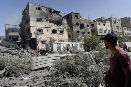 Un palestino observa edificios atacados durante el operativo de las fuerzas especiales israelíes en Nuseirat
