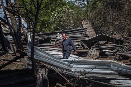 Un residente local camina entre los restos de un edificio industrial que resultó dañado después de un ataque con misiles rusos en Odesa el 18 de mayo de 2023, en medio de la invasión rusa de Ucrania