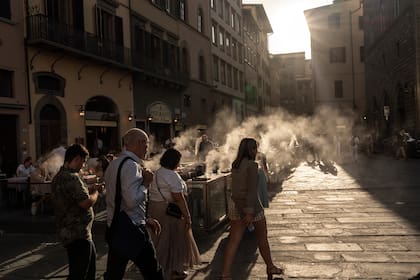 Un restaurante en la Piazza della Signoria utiliza chorros de vapor de agua durante una olar de calor para que los clientes se sientan más cómodos en Florencia, Italia, el 13 de julio de 2023. (Francesca Volpi/The New York Times)