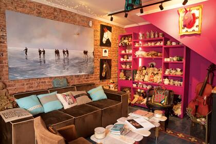 Un rincón donde se ve la gran colección de tazas de té y muñecas antiguas de Marcela.