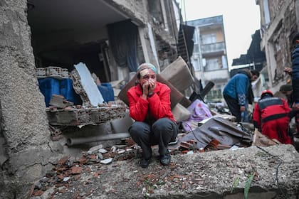 Un sobreviviente del terremoto reacciona mientras los rescatistas buscan víctimas y otros sobrevivientes
(Photo by BULENT KILIC / AFP)