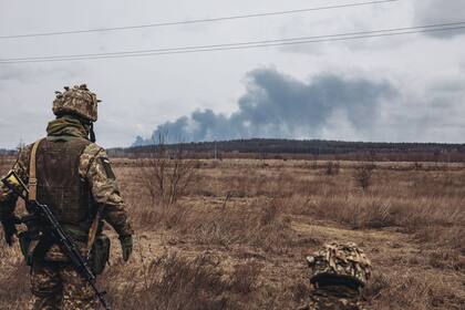 Un soldado del ejercito ucraniano observa el humo de los bombardeos en Irpin, Ucrania. 