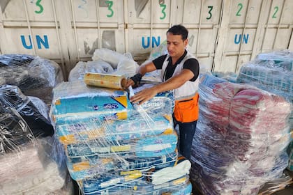 Un trabajador de las Naciones Unidas prepara paquetes de ayuda para su distribución a los palestinos en el almacén de la UNRWA en Deir Al Balah, Franja de Gaza (Archivo)