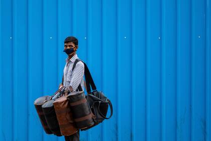 Un vendedor que usa una mascarilla como medida preventiva contra el coronavirus busca clientes para vender sus bolsos en Nueva Delhi el 7 de septiembre de 2020