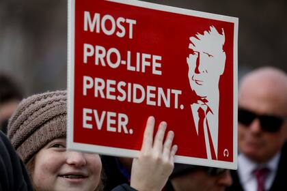 Una activista provida marcha con un cartel de apoyo a Trump