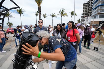 Una astrónoma aficionada prepara su telescopio el día antes de un eclipse solar en Mazatlán, México, el domingo 7 de abril de 2024