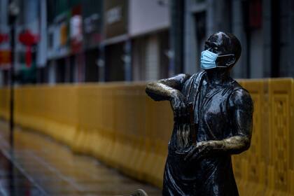 Una estatua con un barbijo en una calle de Wuhan, China