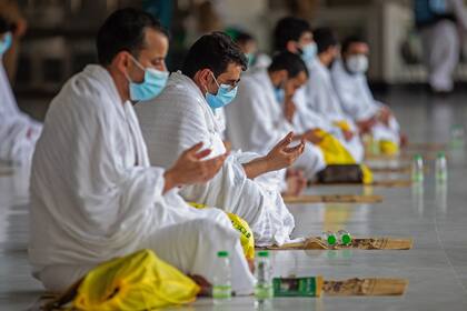 Una imagen del Ministerio de Medios saudí muestra a peregrinos musulmanes, con máscaras protectoras contra la propagación del coronavirus, rezando el 29 de julio de 2020 en la Gran Mezquita de La Meca en Arabia Saudita