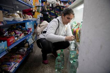 Una mujer compra agua embotellada en un supermercado en Montevideo, Uruguay