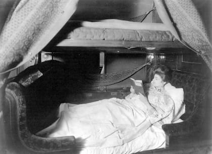 Una mujer lee un libro en un coche Pullman con cama (1905)