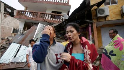 Una mujer llora frente a su casa, destruida por el temblor en la localidad costera de Pedernales