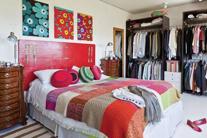 Una propuesta canchera: una antigua puerta recuperada, pintada con un esmalte satinado rojo intenso y convertida en cabecera de un ambiente con mucho estilo