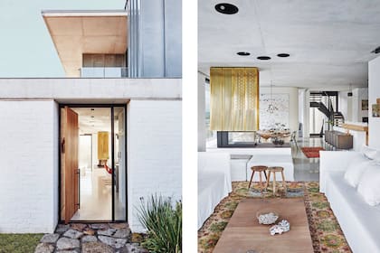 Una puerta pivotante de roble se abre a un interior de pocos materiales, en el que se destacan los pisos de cemento alisado laqueado. La calma blanca de los sofás con fundas de lino se levanta con una serie de kilims coloridos y la larga alfombra traída de Marruecos. Mesa baja de roble macizo (James Mudge).