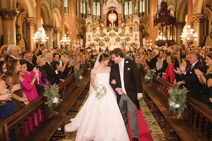 Una romántica imagen de los novios, saliendo felices de la iglesia. Taina eligió un traje de Oscar de la Renta confeccionado en cloqué, con un patrón floral en su diseño. Lo acompañó con velo de tres metros de Monvieve decorado con rosas inglesas silvestres.