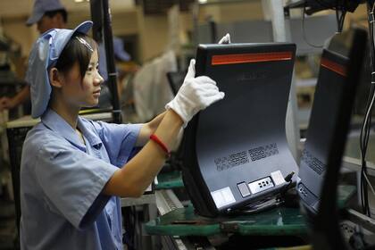 Una trabajadora en la línea de producción que Lenovo tiene en Shangai, China