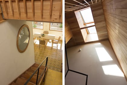 Una ventana circular con vidrio esmerilado deja pasar luz natural al baño. La escalera de cedro con baranda metálica está iluminada por una claraboya.