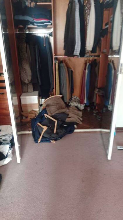 Uno de los vestidores, con ropa tirada, aún puesta en las perchas