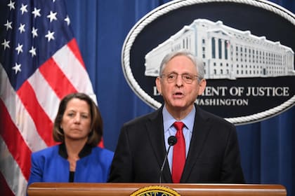 US Attorney General Merrick Garland, with  Deputy Attorney General Lisa Monaco (L), announces an antitrust lawsuit against Apple, at the Justice Department in Washington, DC, on March 21, 2024. Apple on Thursday warned that the lawsuit over alleged monopolistic practices by the iPhone maker could set a dangerous precedent on government intervention. (Photo by Mandel NGAN / AFP)�