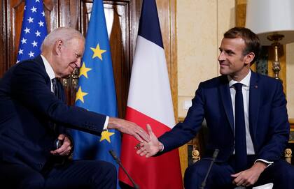 U.S. President Joe Biden, left, shakes hands with French President Emmanuel Macron during a meeting at La Villa Bonaparte in Rome, Friday, Oct. 29, 2021. A Group of 20 summit scheduled for this weekend in Rome is the first in-person gathering of leaders of the world's biggest economies since the COVID-19 pandemic started. (AP Photo/Evan Vucci)
