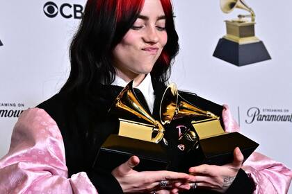 US singer-songwriter Billie Eilish poses in the press room with the Grammys for Song of the Year and Best Song Written Visual Media for "What Was I Made For?" during the 66th Annual Grammy Awards at the Crypto.com Arena in Los Angeles on February 4, 2024. (Photo by Frederic J. Brown / AFP)