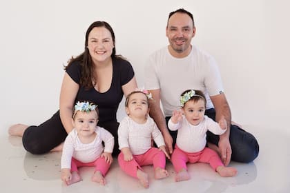 Vanina Catalá y Leonel Chainski posan junto a sus hijas, las trigemelas Victoria, Julieta y Delfina