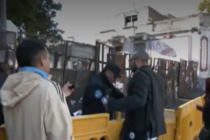Vecinos gritaban desde detrás de una valla puesta por la Policía de la Ciudad