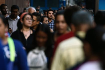 Viajeros que no pudieron usar el subte debido a un corte de energía parcial acuden a las calles de Caracas el 7 de marzo de 2019.