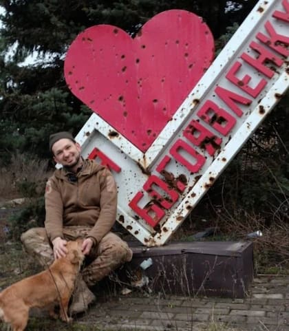 Viktor Pylypenko junto a un cartel con marcas de balas en el frente de batalla de la guerra entre Rusia y Ucrania